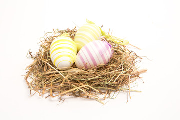 Three easter eggs in straw