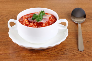 serving of tomato soup in a white plate