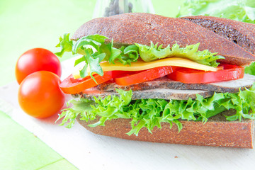 Sandwich with beef, cheese and vegetables