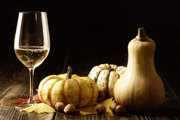 Pumpkins and autumn leaves with white wine
