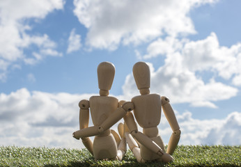 two wooden puppets as loving couple