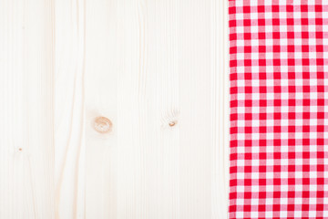 White and red tablecloth texture on wooden table background