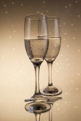 Flutes of champagne in holiday with abstract lights