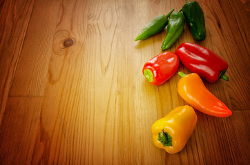 Peppers on wooden background