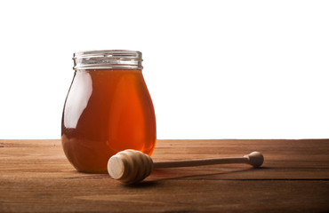 Honey drip in jar on the table
