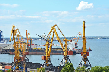 Cargo crane, freight ship and coal in port
