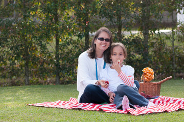 Pretty Mother And Girl Having Picnic In Park