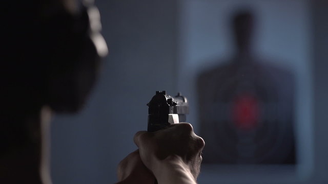 Over the shoulder of shooter, practicing on a target