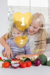 Mother and daughter chopping vegetables with yellow holographic