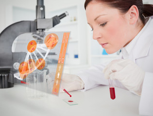 Scientist pouring drop of blood onto glass with futuristic inter