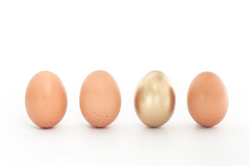 Four eggs in a row with one gold one