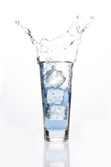 Big ice cubes falling in a filled glass
