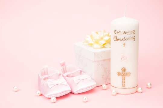 Christening candle with pink baby booties and gift box
