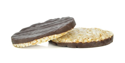 Two chocolate coated rice cakes on a white background