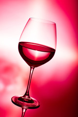 glass of wine on red
