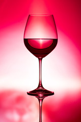 glass of wine on red