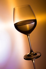 glass of wine on golden background