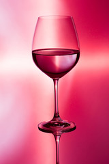 glass of wine on red