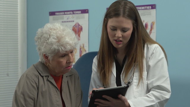 Female doctor talking to patient using a tablet to explain