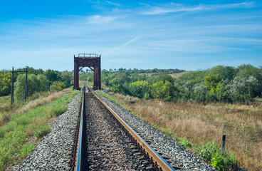 Fototapeta na wymiar Ukrainian summer landscape with small railroad bridge.