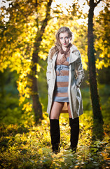Fototapeta na wymiar sexy girl with long leather boots and short dress in autumn park
