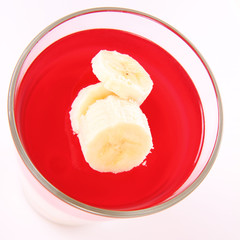 Pudding dessert with bananas and raspberry jelly
