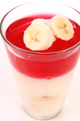 Pudding dessert with bananas and raspberry jelly