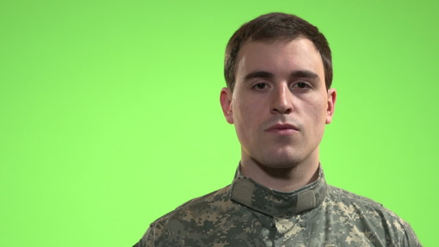 Soldier in front of green screen.