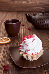 cake and tea on a wooden background.