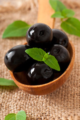 Black olives on a wooden table