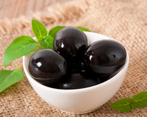 Black olives on a wooden table