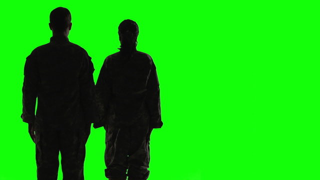 Soldiers Silhouette in front of green screen. Facing back