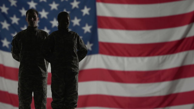Soldiers Silhouette in front of American flag.