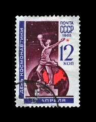 Cosmonauts monument in Moscow, USSR. Human with first soviet  satellite in hands. vintage postal stamp isolated on black background.