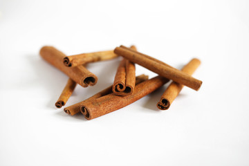 Cinnamon bark sticks, curled, isolated on white