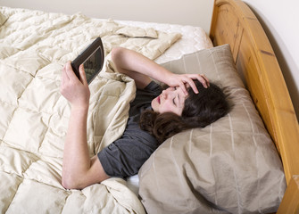 Young girl frustrated by wakeup of alarm clock