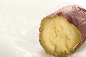 close up of grilled sweet potato on white background