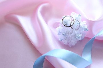 blue artificial flower with platinum rings for wedding image