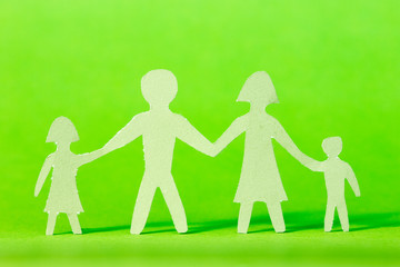 Paper family on green background