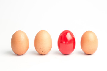Four eggs in a row with one red one