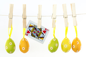 Easter eggs hanging from a line with queen of hearts