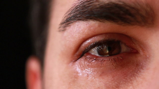 Closeup man eye crying