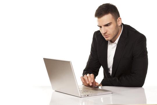 concentrated young businessman working on his laptop