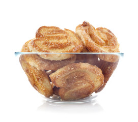 Glass bowl of cookies. Isolated on white background