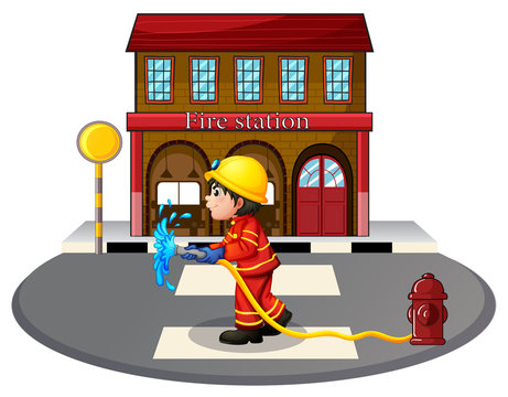 A fireman holding a fire hose near a hydrant