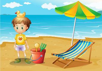 Een jonge jongen en zijn speelgoed op het strand