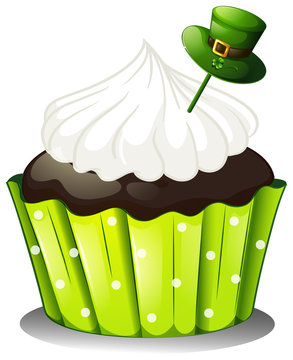 A chocolate cupcake with a white icing and a green hat