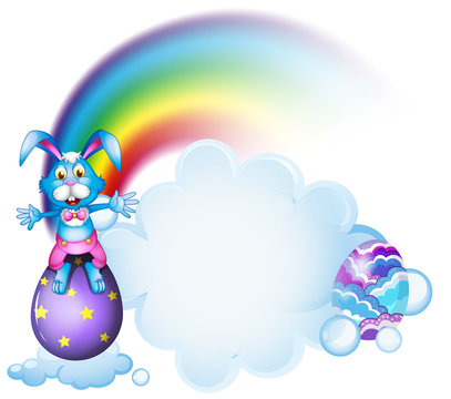A bunny above the egg near the rainbow