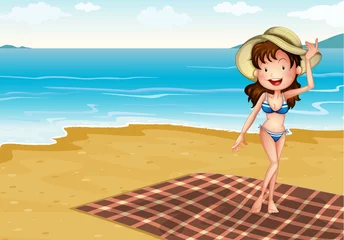 Gordijnen Een meisje op het strand met een deken © GraphicsRF