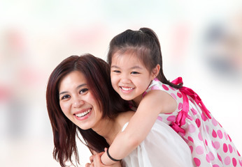 Asian family piggyback ride at home.